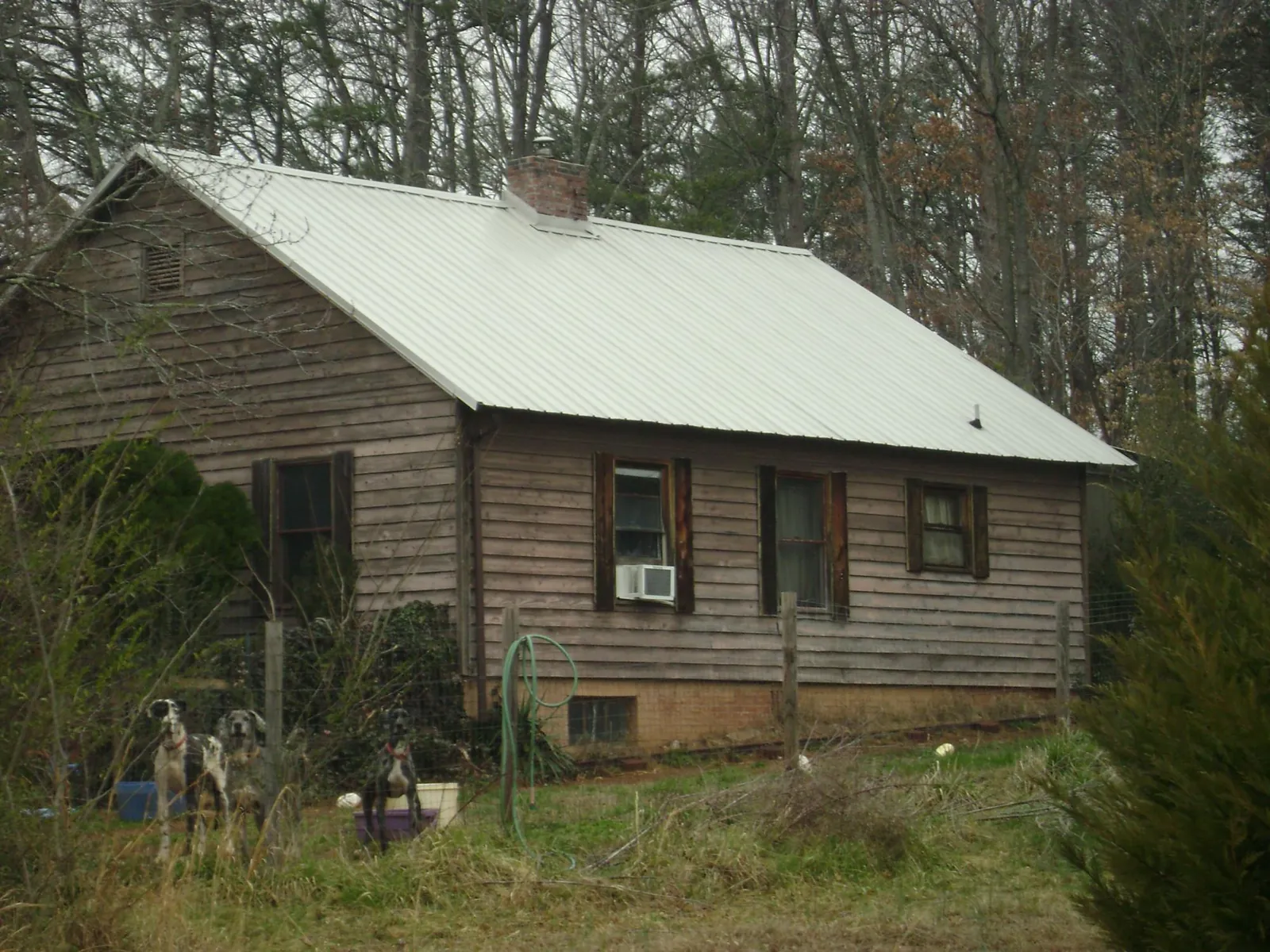 White metal roof on an old wood sided farmhouse, from a Metal Roof Installation job in Ashley Falls